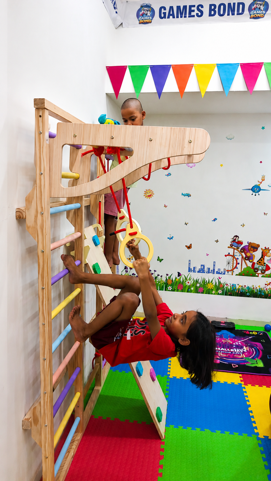 Children climbing and playing on the colourful GAMES BOND jungle gym